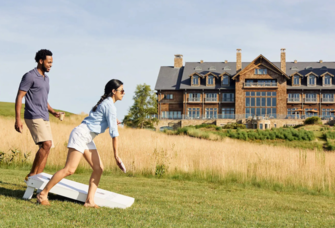 Couple playing cornhole together at Primland Resort Meadows of Dan, Virginia, romantic getaways in Virginia