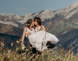 wedding couple kissing with montana mountain backdrop