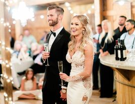 bride and groom with champagne flutes at wedding reception