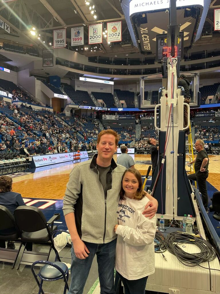 Steve brings Sarah to her first UConn basketball game, predicting a national championship.