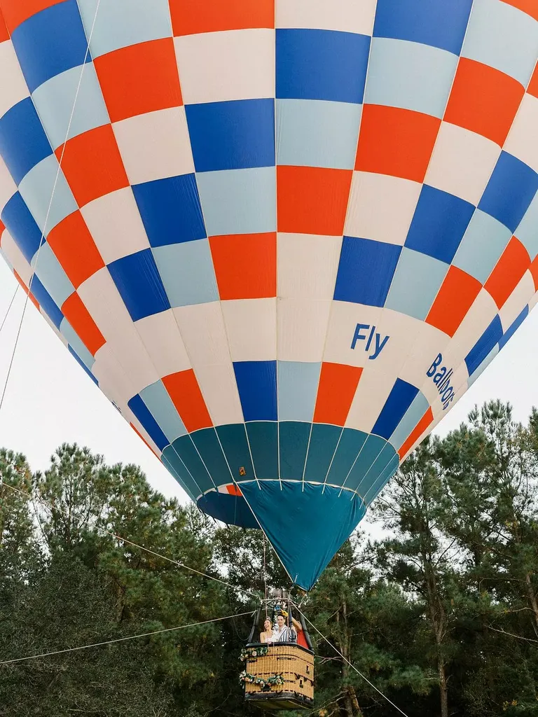 Bride and Groom in Massive Blue, White and Red Hot Air Balloon Entrance