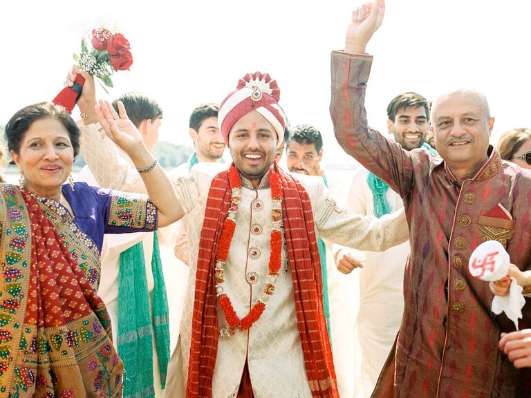 A groom and his parents celebrate on the big day.