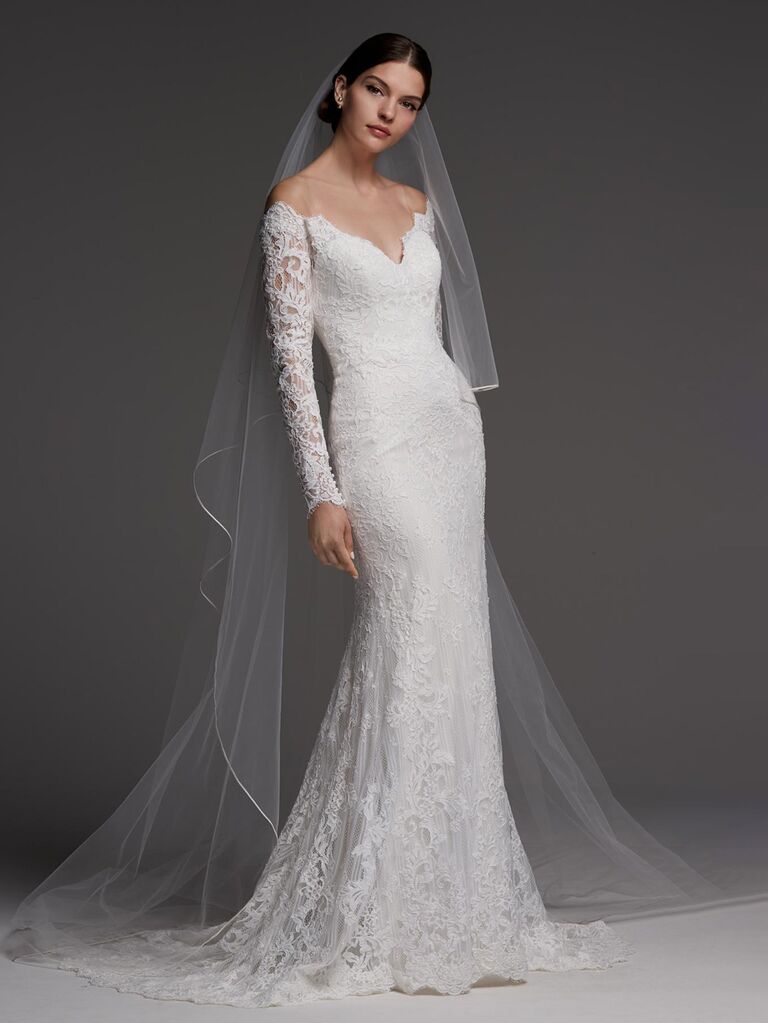 watters ivory and oyster colored off the shoulder wedding dress with v-neckline allover lace long sleeves and form fitting skirt