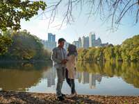 A couple standing together at Piedmont Park in Atlanta, GA