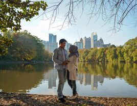 A couple standing together at Piedmont Park in Atlanta, GA