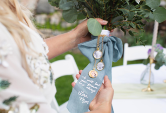 bride holding bouquet in custom wrap with message from mom