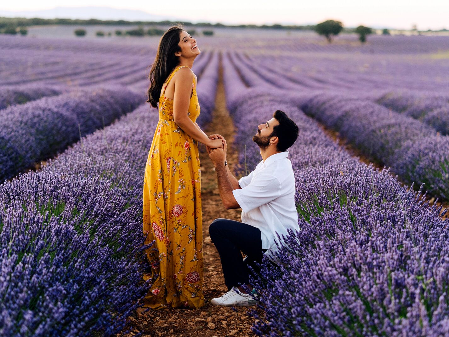 Man proposing to woman in lavender field