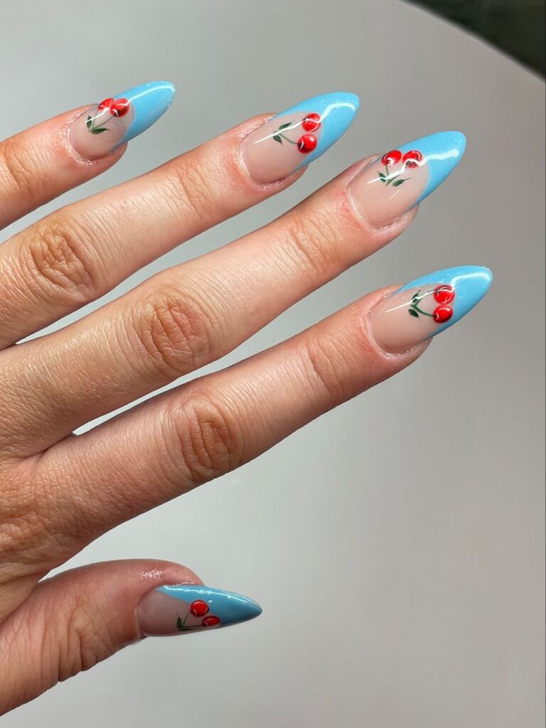 pale blue and bright red cherries nail inspo