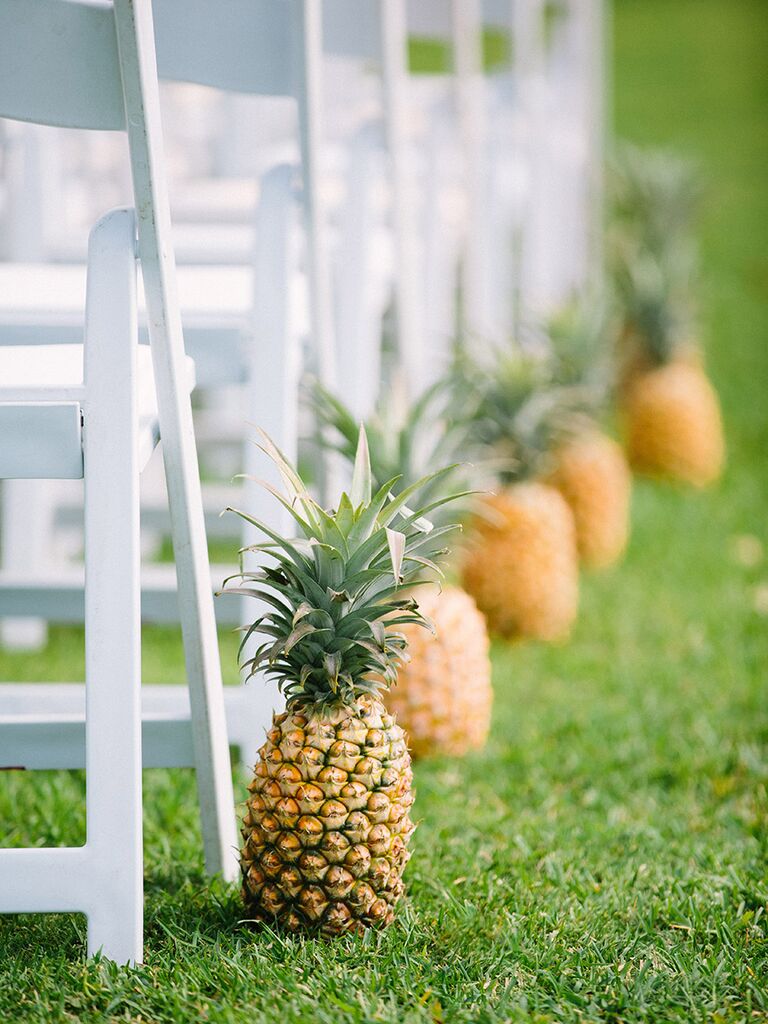 Festive pineapples for tropical wedding aisle decor
