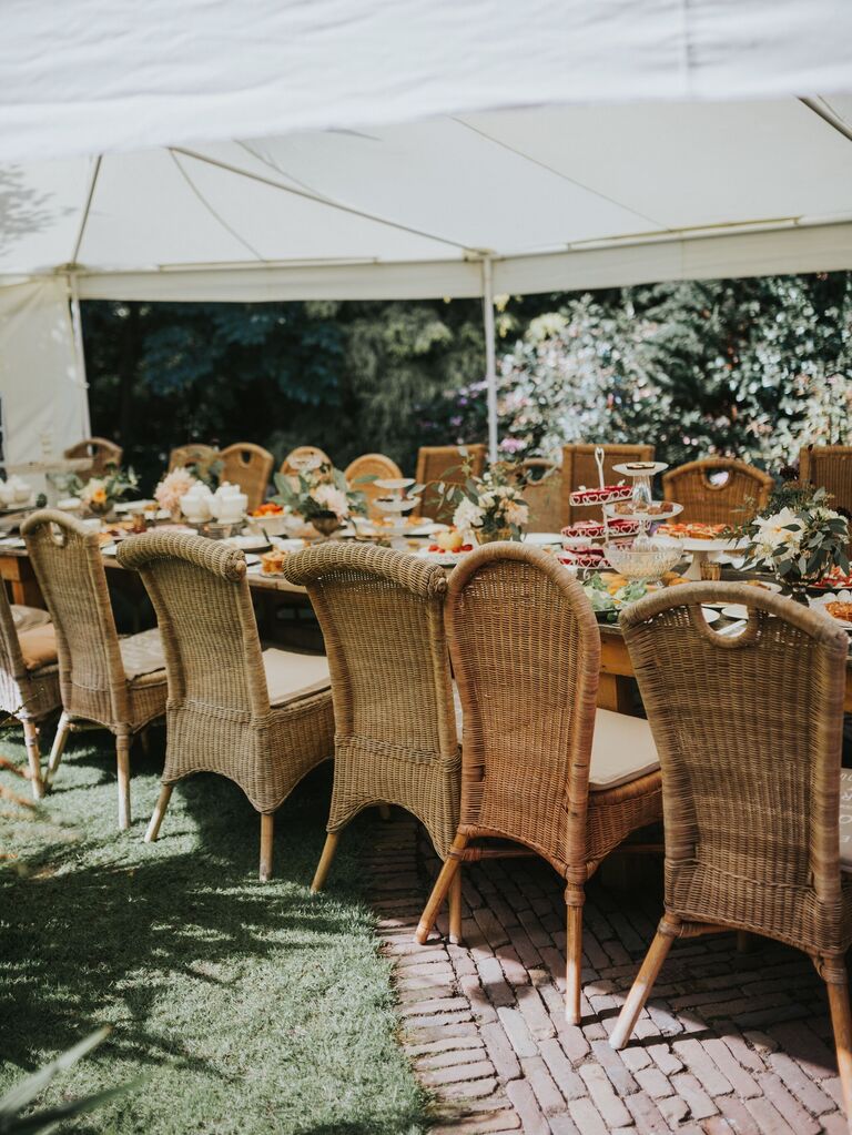 long wedding banquet table with mismatched rattan chairs
