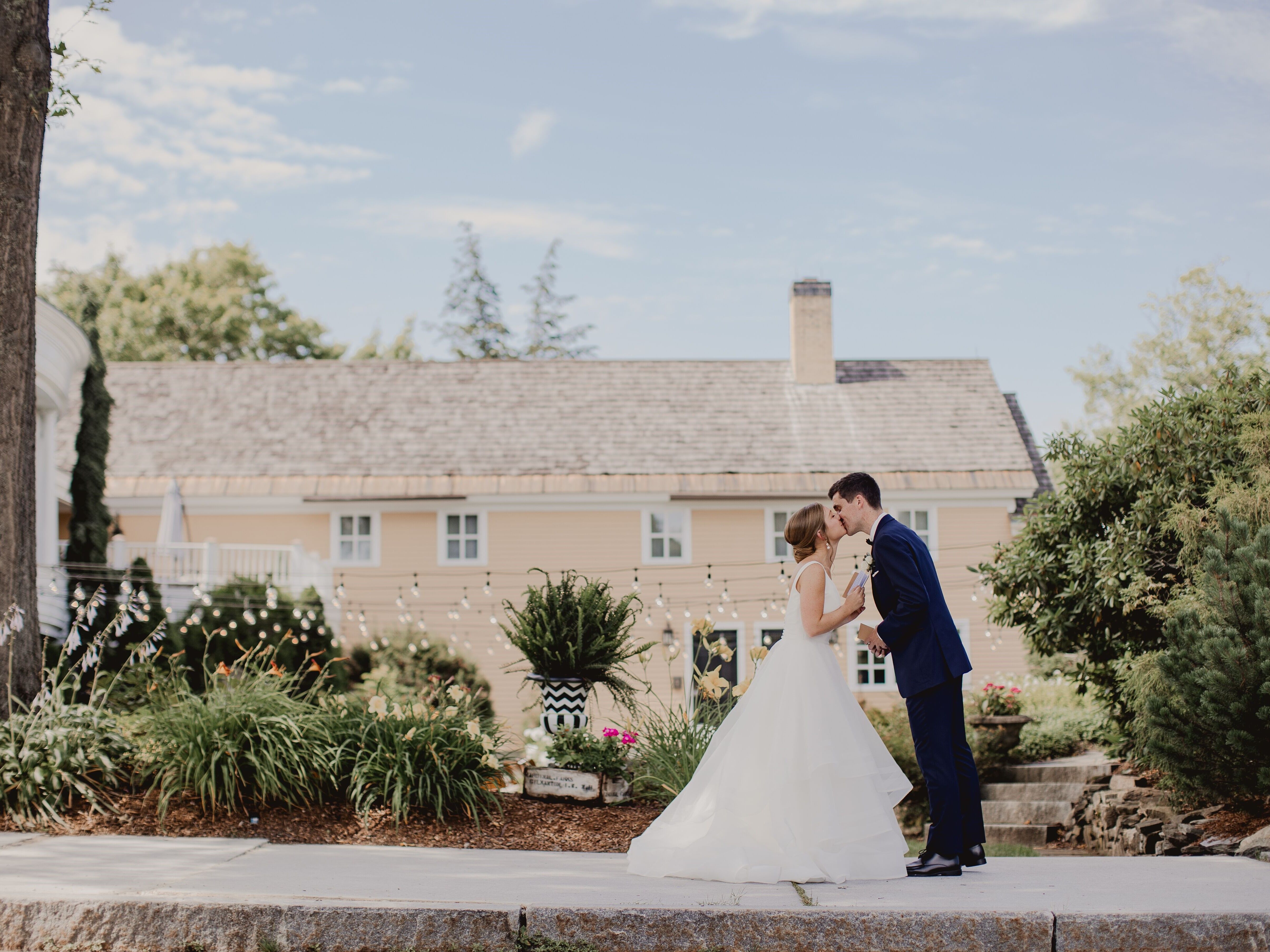 Couple kissing in the garden outside of The Bedford Village Inn