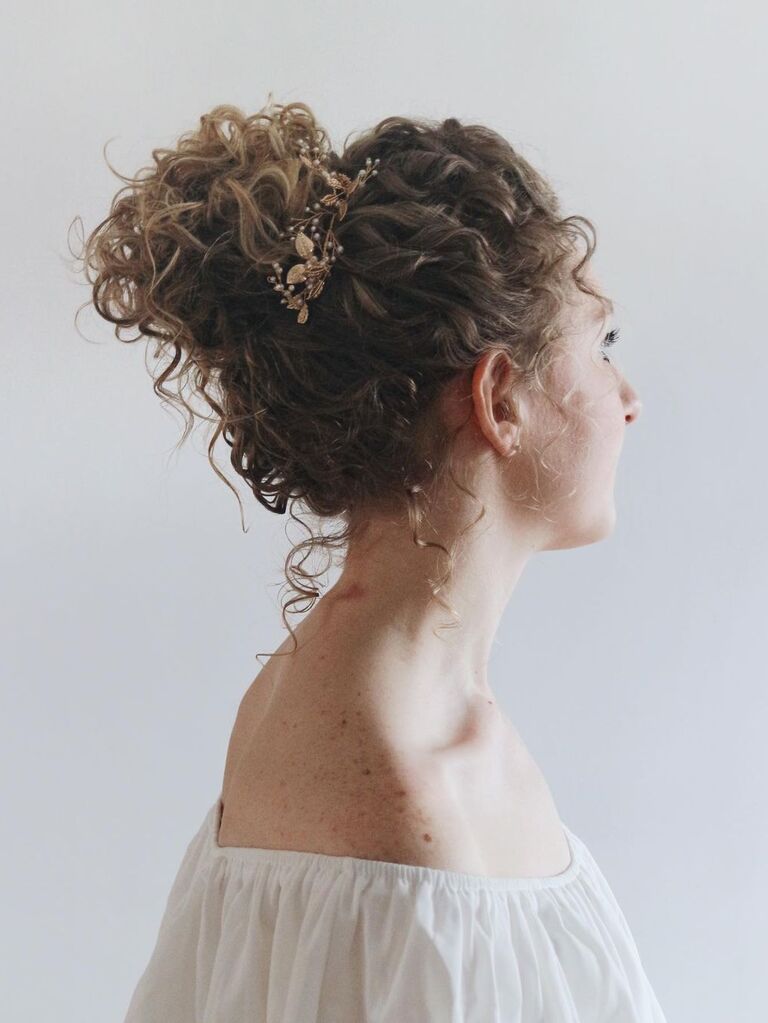 Naturally curly bun wedding updo for long hair