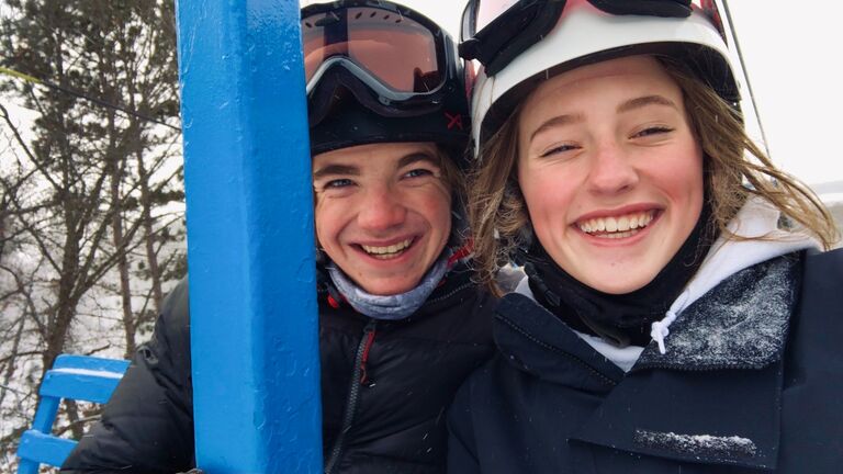 Downhill skiing together for the first time.