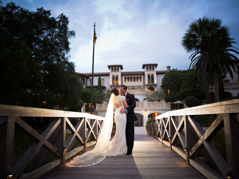 bride and groom kiss on the bridge at Sea Island Resort