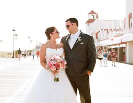 New Jersey wedding couple posing on boardwalk in sunglasses