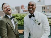 Two men laughing on wedding day