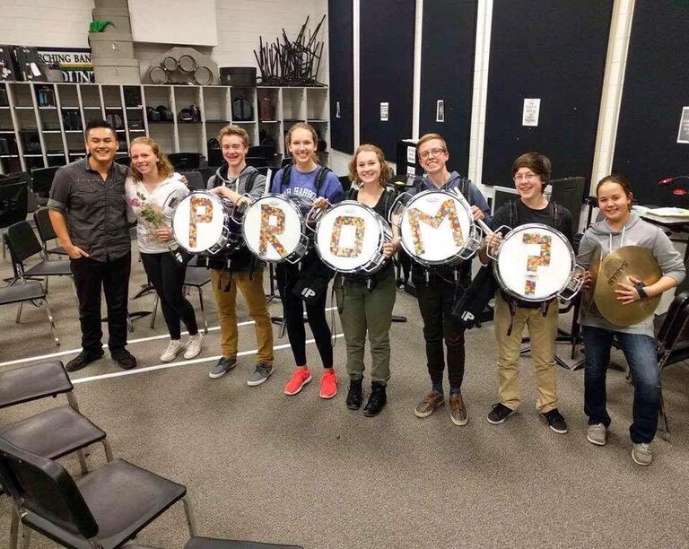 Kai asks Anna to the Junior Year Prom. Anna's Maid of Honor, Maija (center left), and Officiant, Petra (center right), helped make the special moment a success!