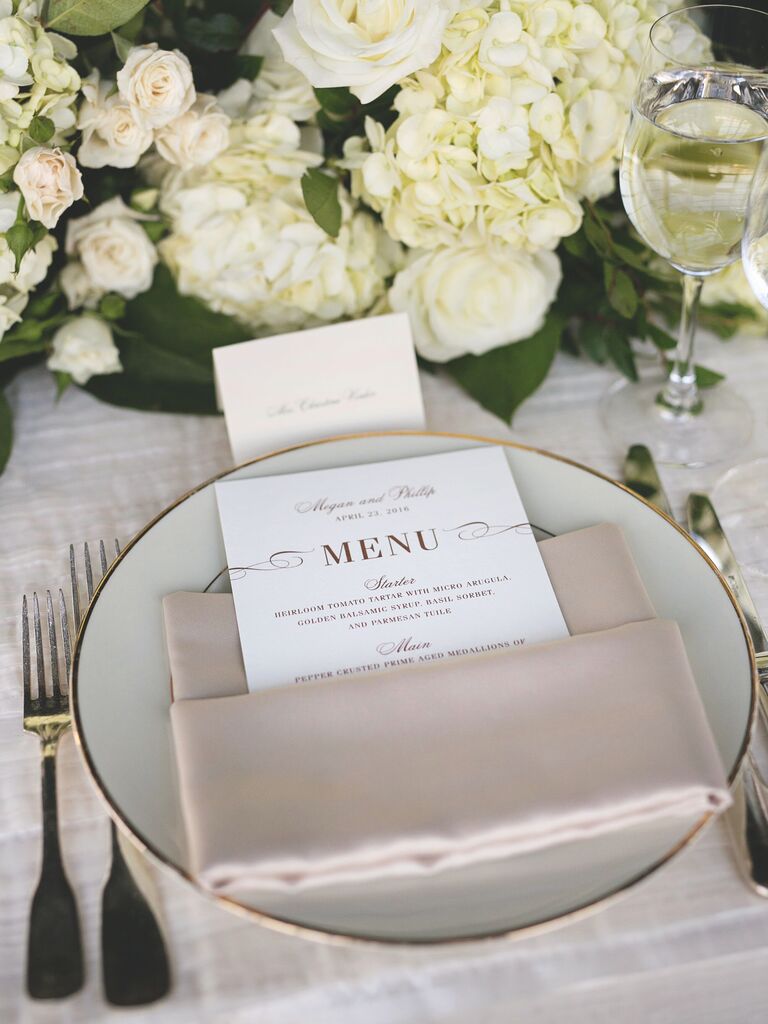 This chic wedding place setting features timeless colors in white, beige and gold.