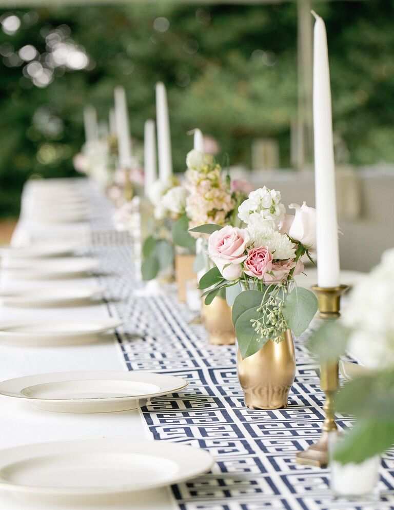 White and blue patterned table running with tall taper candles