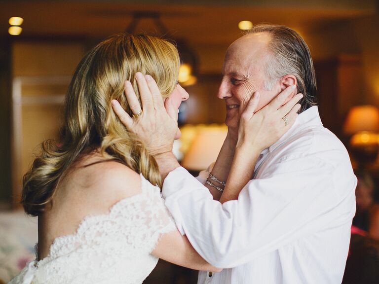 Father grabbing his daughter's face on the wedding day