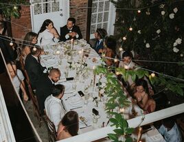 Wedding guest and couple gathered at table for wedding dinner party