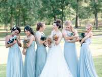 Bride and bridesmaids holding puppies instead of bouquets