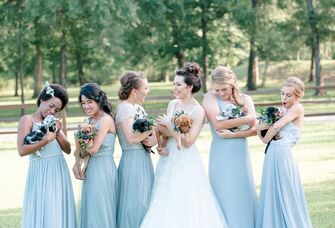 Bride and bridesmaids holding puppies instead of bouquets