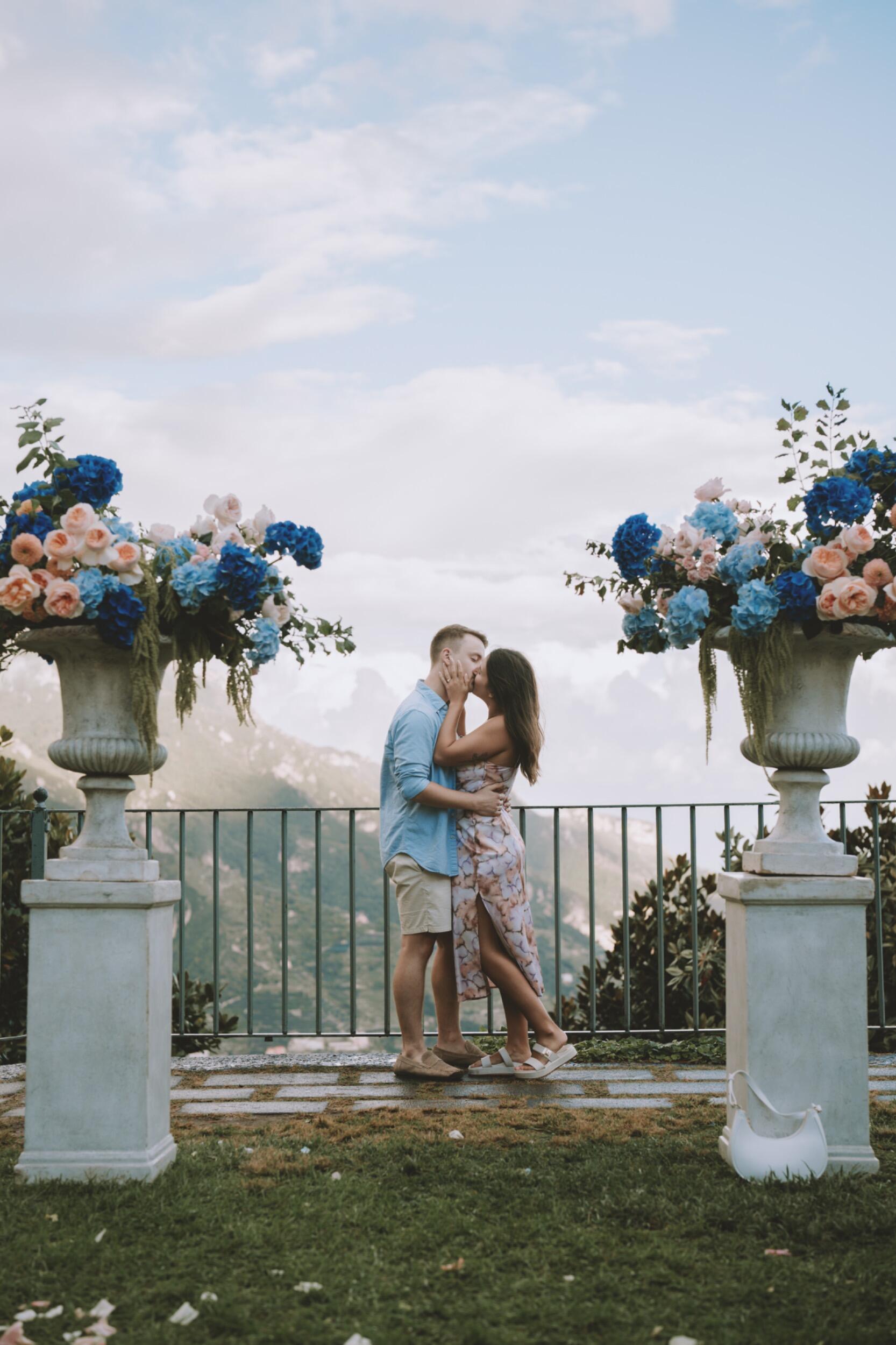 On a cliffside in Italy, Léo proposed, and Joani said YES! As the moment unfolded, photographers jumped out from behind trees to capture the beautiful scene. They then led Joani and Léo around the picturesque town of Ravello for a private photoshoot, allowing them to fully soak in the moment and enjoy what had just happened. It was the most romantic day, filled with so much fun, as they smiled and giggled for the camera.
