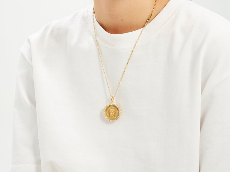 Gold pendant necklace by Greg Yuna. 
