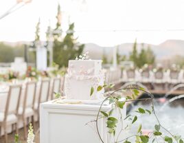 Floral appliques icing on a square wedding cake at the reception