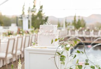 Floral appliques icing on a square wedding cake at the reception