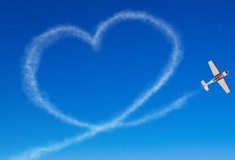 Plane creating a heart in the sky