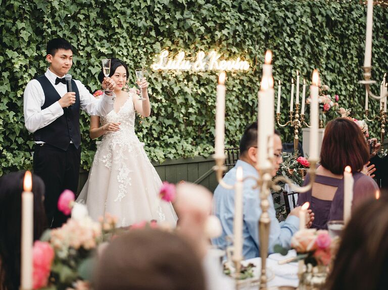 A couple making a toast at their wedding
