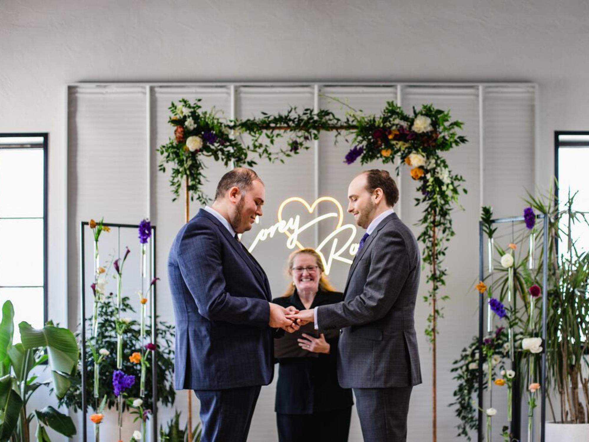 Couple getting married at ceremony with officiant