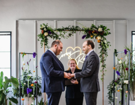 Couple getting married at ceremony with officiant