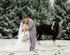 Couple in a snowy garden at The Estate at Sunset Farm