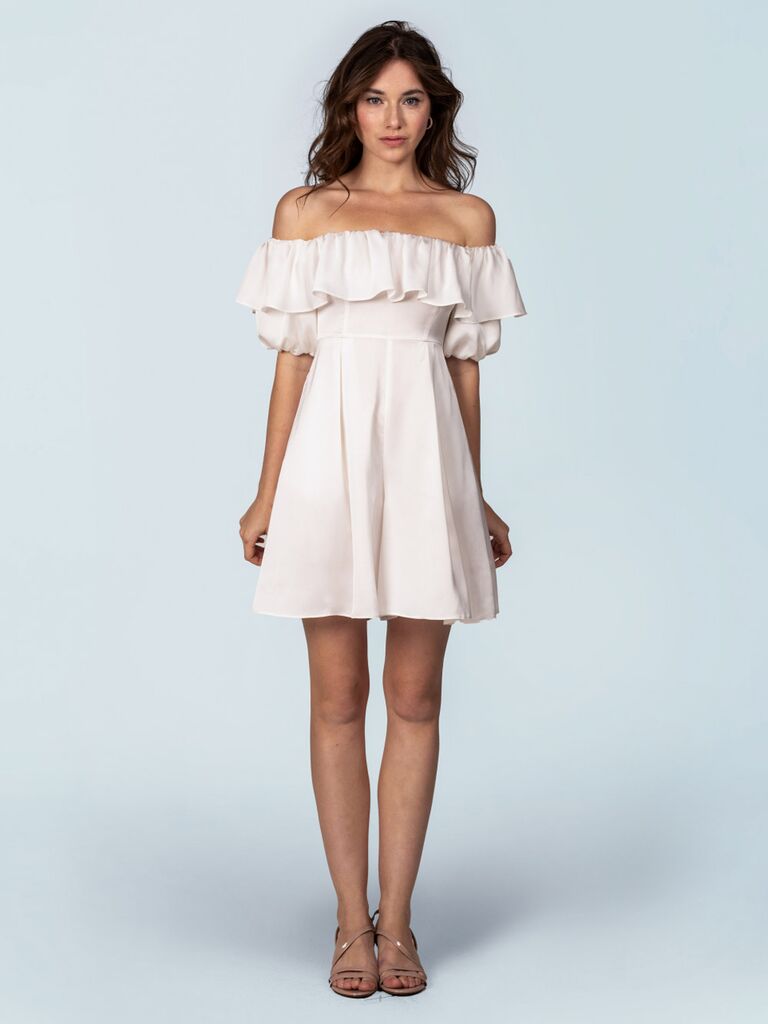 fame and partners ivory satin bridal romper with off the shoulder sleeves ruffle trimmed neckline and flowy wide-leg shorts