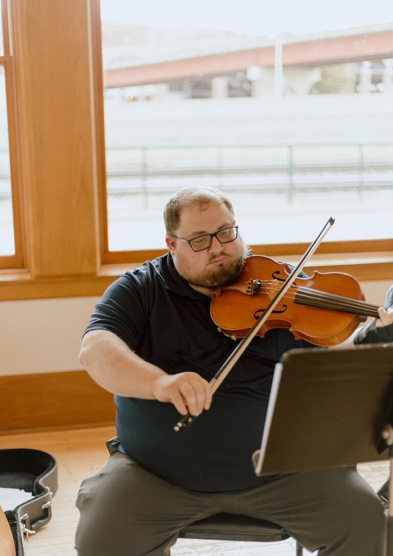 Here's Adam playing the viola for the wedding of his groomsmen, Zach.