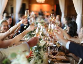 guests toasting with champagne glasses seated at a table