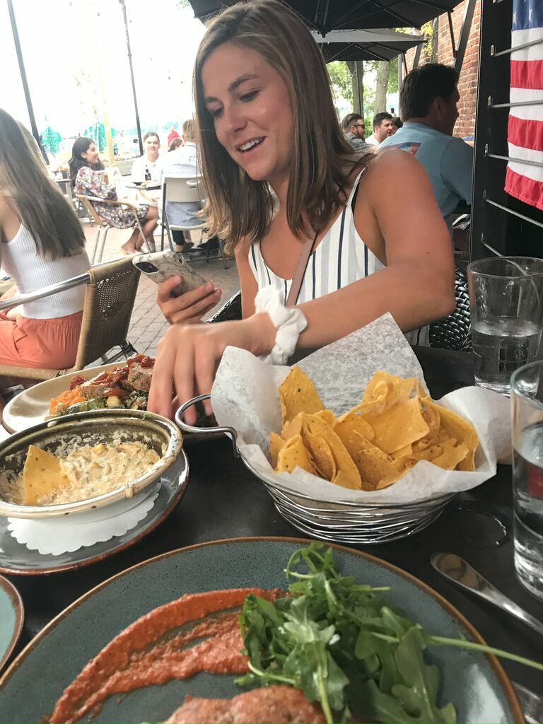 Our very first fancy dinner together! Tom capturing the rare moment of Hallie preparing 'the photo' by rearranging the food.