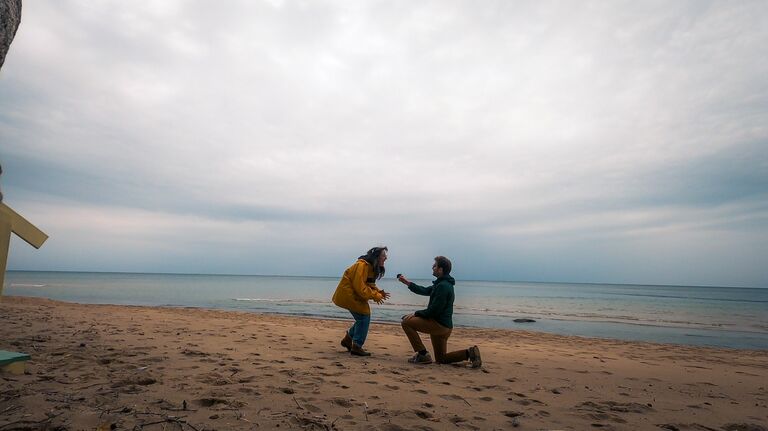 At long last! Nick proposed to Megan on the beach in Michigan. (On a Friday the 13th, no less!) She was so excited, she forgot to say "Yes!" until Nick asked her again.