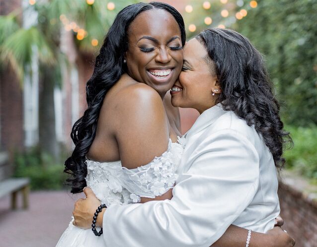 two brides snuggling and laughing