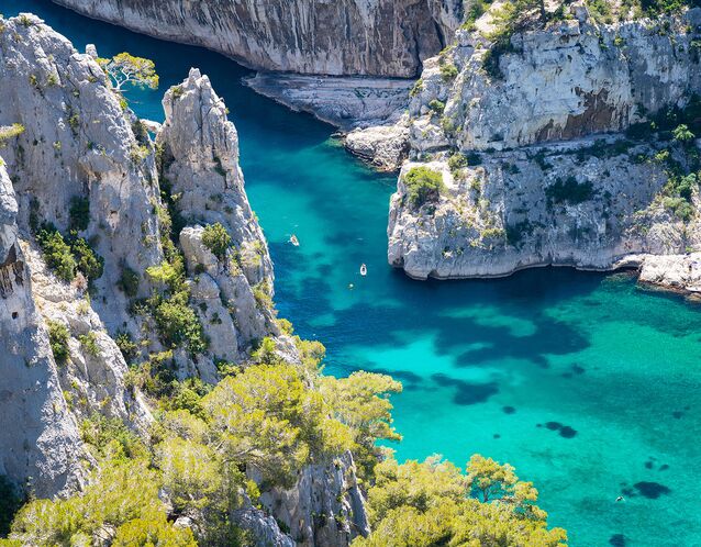 best honeymoon destinations a beautiful photo of gordes south of france with massive rocks and teal blue water plus kayaks