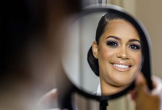 Bride applying makeup