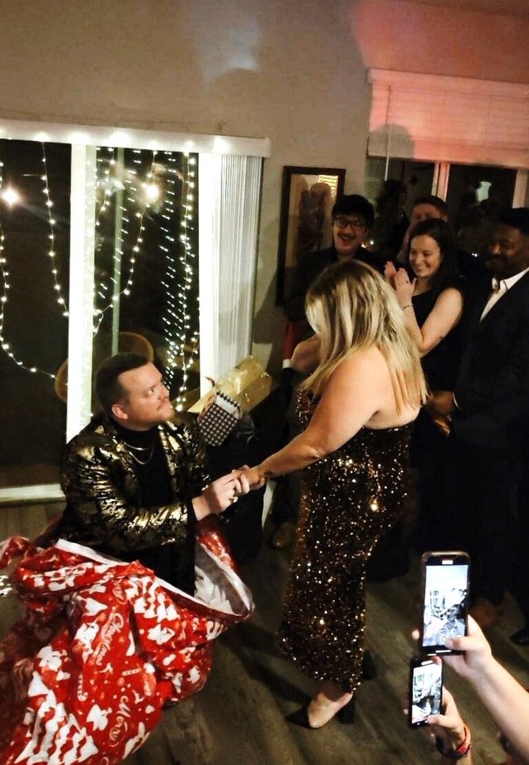 The big moment: Engaged!! Mike surprised Chelsea at the Annual Holiday Soirée during the white elephant gift exchange. 