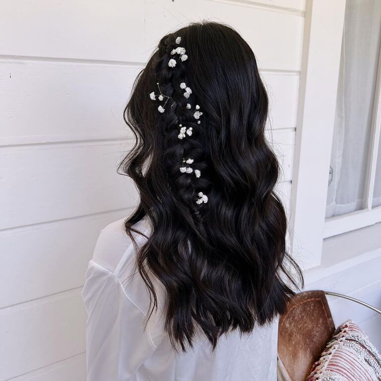 Wedding guest hairstyle with curls and floral accessories