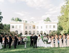 Couple exchanging their vows outside a grand wedding venue