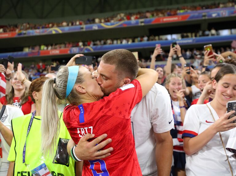 Zach and Julie Ertz kissing at a game