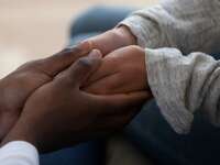 Black couple holding hands.