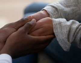 Black couple holding hands.